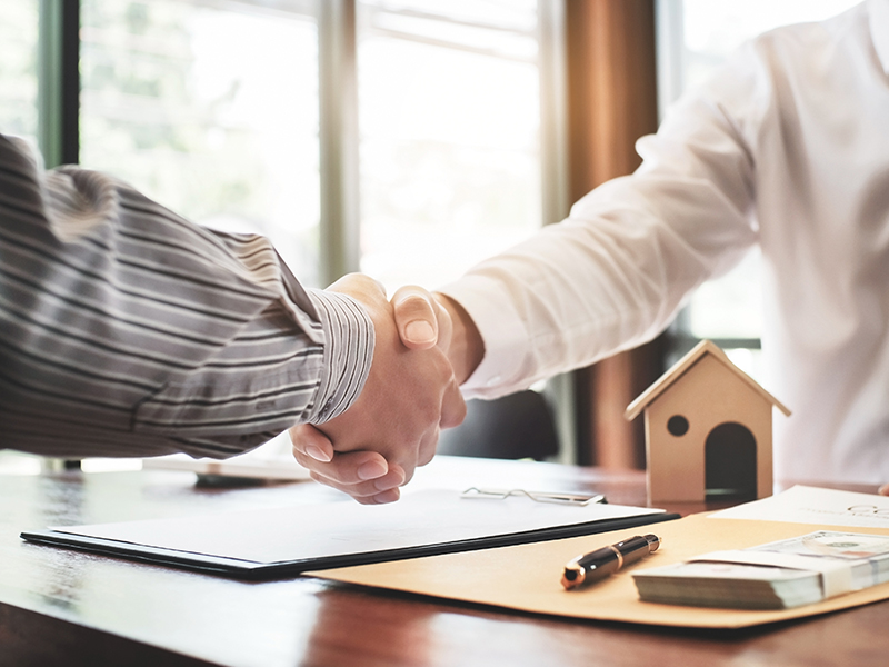 Real estate agent shaking hand with customer