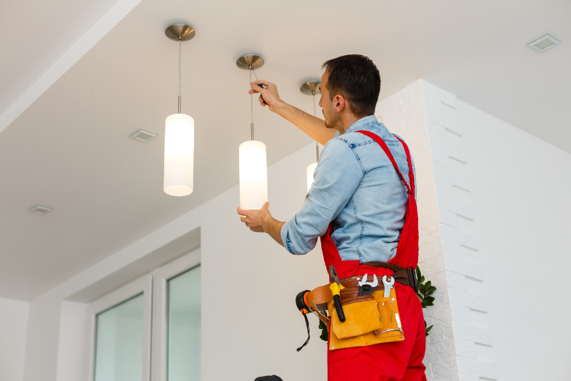 Electrician fixing light bulb