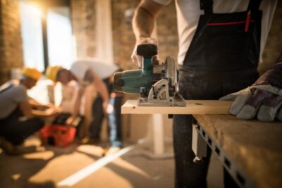 Worker Cutting Plank